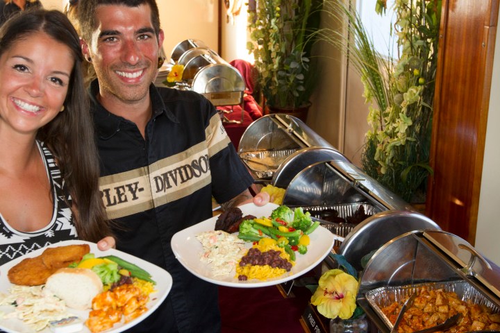 a woman sitting at a table with a plate of food