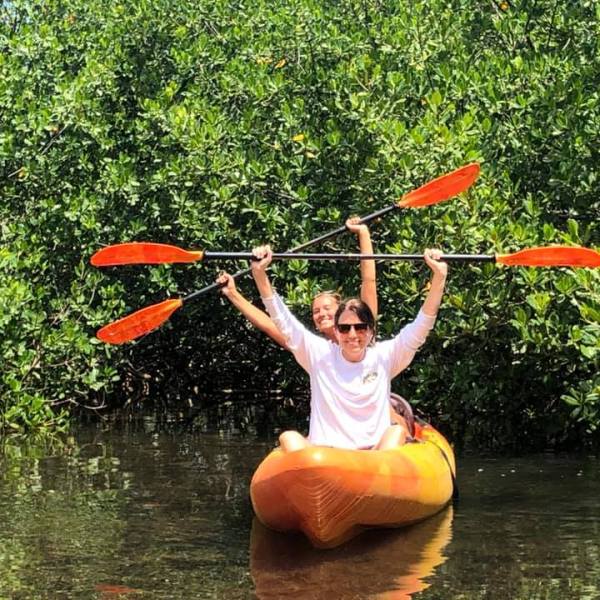 a person throwing a frisbee in a body of water